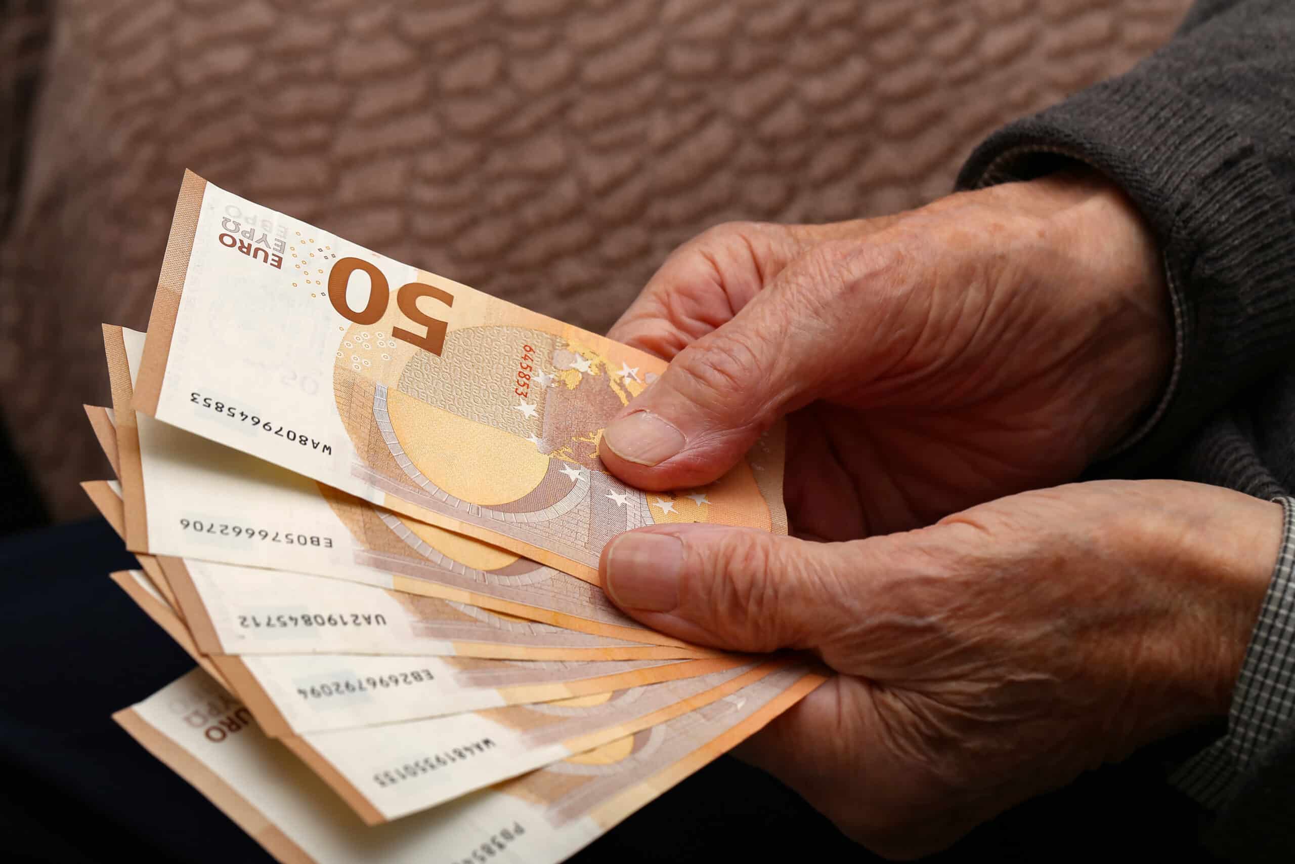 closeup shot of money in the hands of an old man